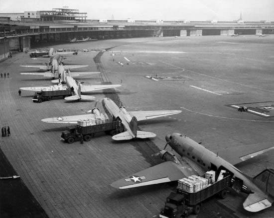 U.S. Navy Douglas R4D and U.S. Air Force C-47 Skytrains unload at Tempelhof Airport during the Berlin Airlift in 1948