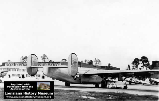 B-24 on apron at Seymour Johnson Field in WWII, hangars in background