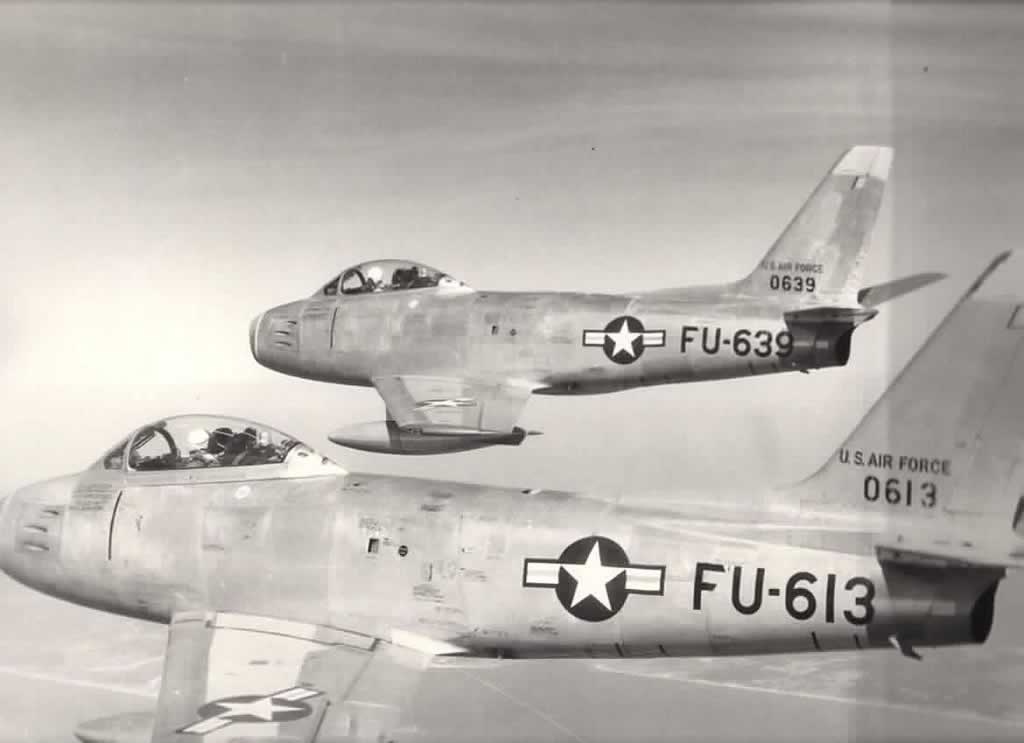 U.S. Air Force F-86E Sabres flying in information ... S/N 50-0613, Buzz Number FU-613 (foreground, and S/N 50-0639, Buzz Number FU-639 (background)