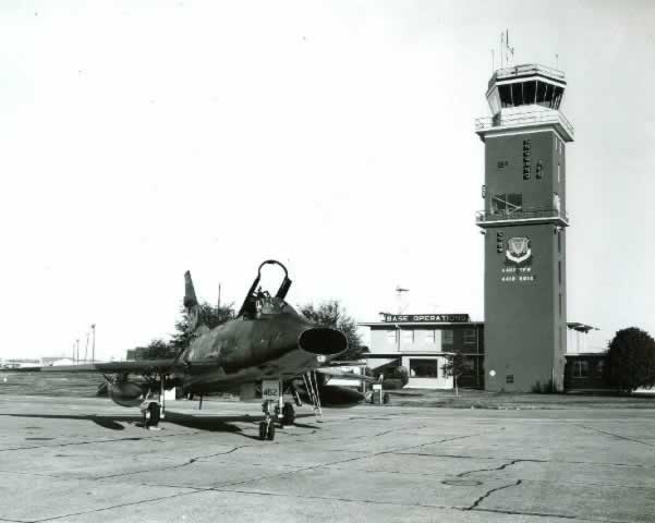 F-100 Super Sabre 462 parked near the England Air Force Base Tower and Operations