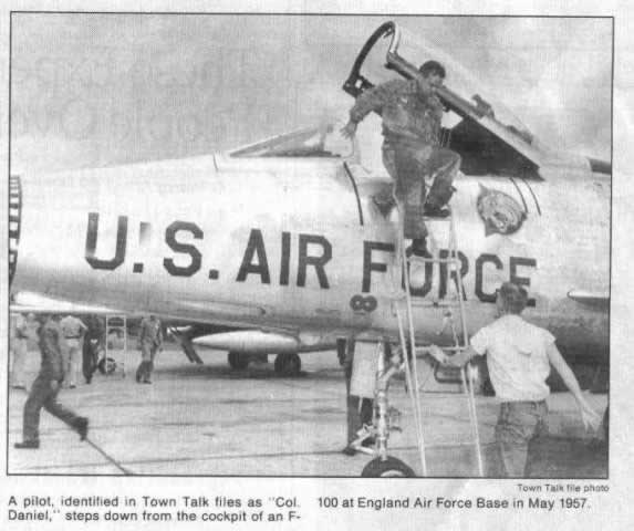 Newspaper account: A pilot identified as Colonel Daniel steps down from the cockpit of an F-100 at Eng at England Air Force Base in May of 1957