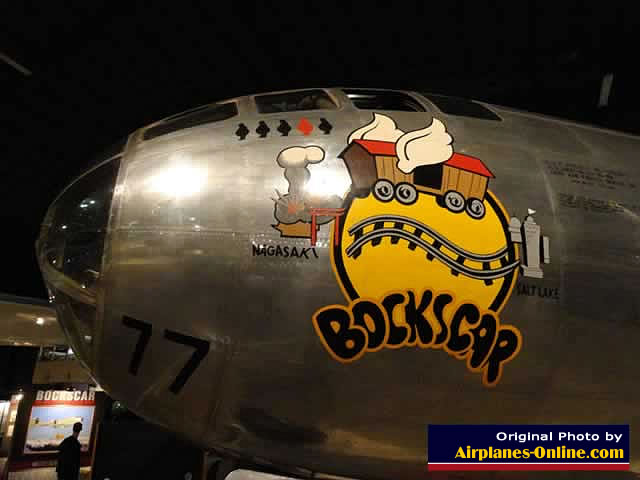 Left nose view of the B-29 "Bockscar" showing four black "pumpkin" bombs, and one red "Fat Man" atomic bomb