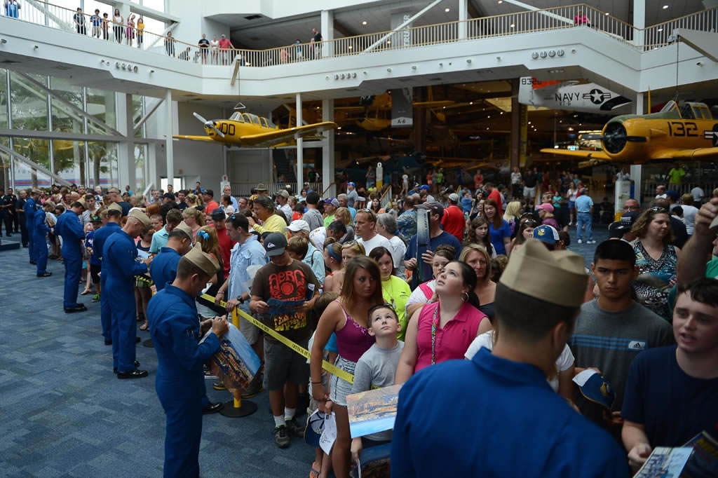 U.S. Navy flight demonstration squadron, the Blue Angels, sign autographs at the National Naval Aviation Museum