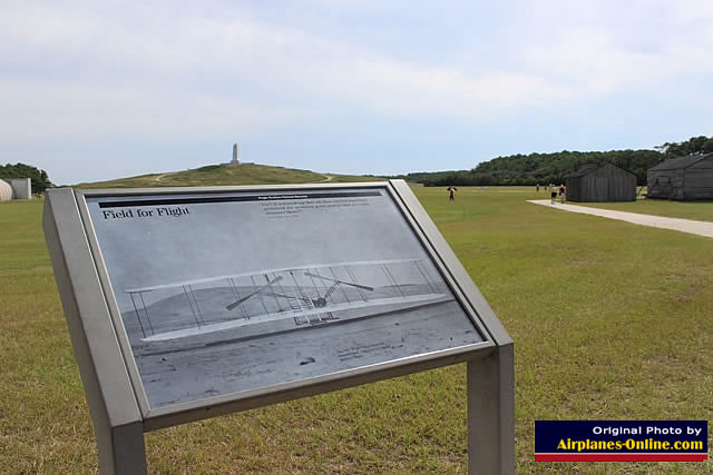 Wright Brothers "Field for Flight", with monument in the distance, and rebuilt hangars to the right